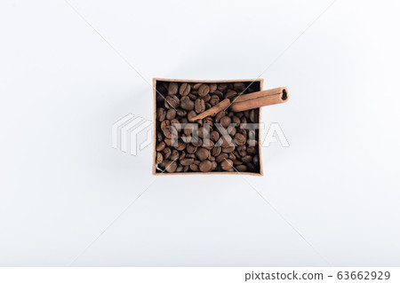 Coffee beans and cinnamons in a cardboard box. top view Coffee beans and cinnamons in a cardboard box. top view 63662929