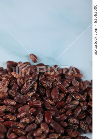 Red beans seeds stock over blue marble 63663000