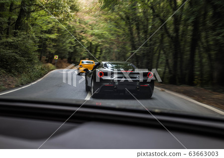 Brand model sport cars driving in the forest road 63663003