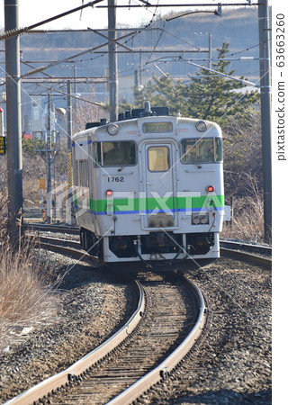 Shooting the scenery of a regular train arriving and departing from JR Wanishishi Station in Muroran City, Hokkaido in early spring 63663260