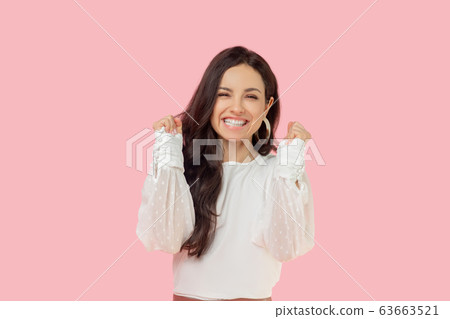 Young woman in a white blouse looking happy 63663521