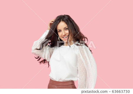 Young pretty brunette woman in a white blouse feeling determined Young pretty brunette woman in a white blouse feeling determined 63663730