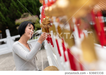 woman look at the golden bells woman look at the golden bells 63665338