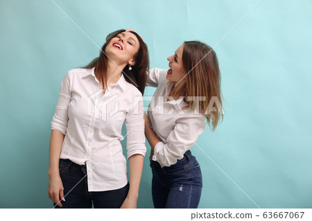 Fashion girls posing on a blue background 63667067