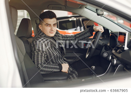 Handsome and elegant man in a car salon 63667905