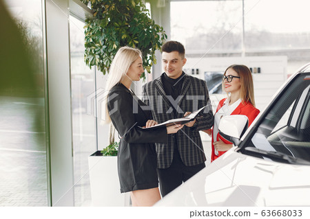 Stylish and elegant people in a car salon Stylish and elegant people in a car salon 63668033