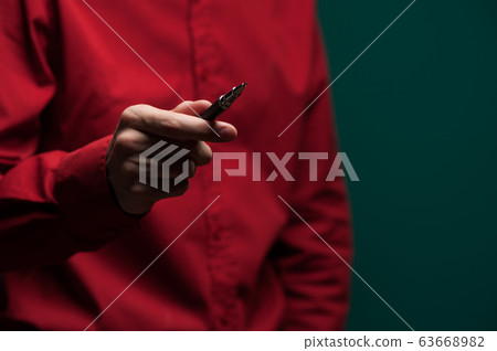 Man's hand with pen 63668982