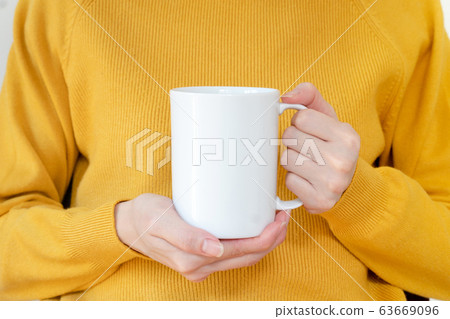 Mug mockup. Women's hands holding mug with blank 63669096