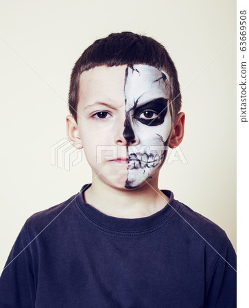 little cute boy with facepaint like skeleton to celebrate halloween, lifestyle people concept, children on holiday 63669508