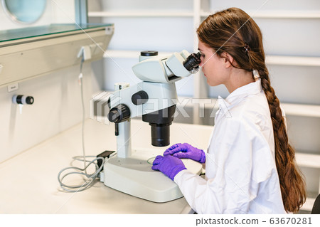 Scientist conducts study of biological material in 63670281