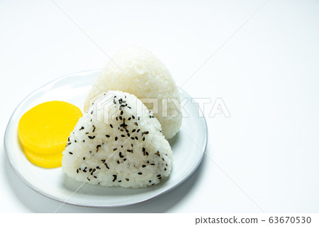 Triangle rice ball. Served with pickles. (White background) 63670530