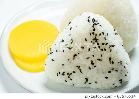 Triangle rice ball. Served with pickles. (White background) 63670534