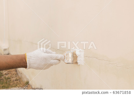Paint to seal the cracks on the concrete wall. 63671858