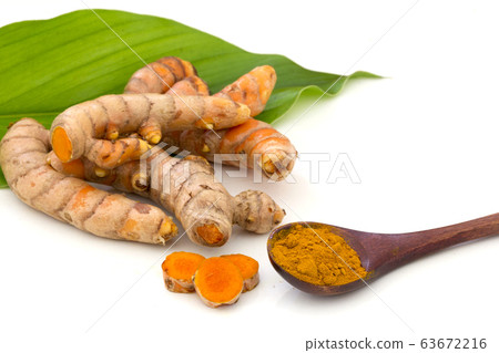 Turmeric (curcumin) powder in wooden spoon 63672216
