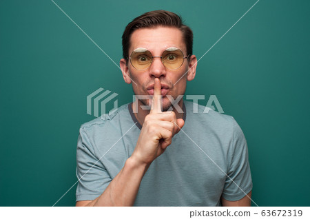 Portrait of a pensive serious young man in shirt Portrait of a pensive serious young man in shirt 63672319