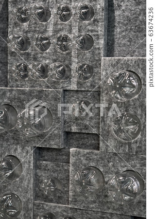 Gray installation with many inserted plastic bottles Gray installation with many inserted plastic bottles 63674236