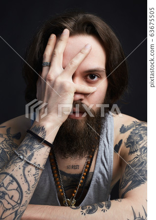 portrait of handsome man with beard and tattoo portrait of handsome man with beard and tattoo 63675505