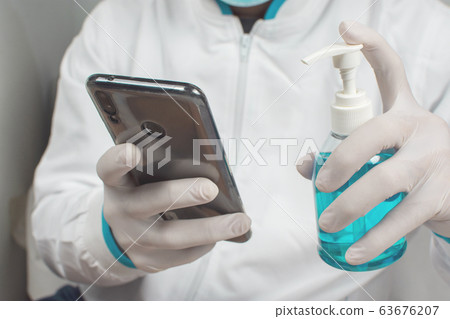 Alcohol sanitizer in the hand are cleaning the smartphone for against infection. 63676207