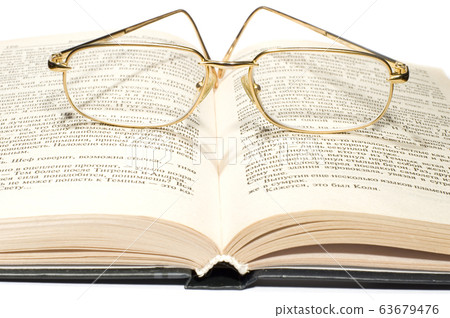 Book with glasses 63679476