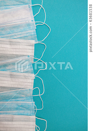 Medical disposable face masks on a blue background. coronavirus covid 19. World pandemic coronavirus Medical disposable face masks on a blue background. coronavirus covid 19. World pandemic coronavirus 63681538