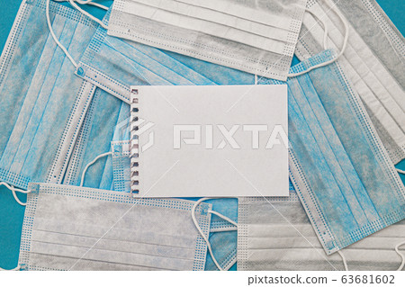 Medical disposable face masks on a blue background with a place for text. coronavirus covid 19 Medical disposable face masks on a blue background with a place for text. coronavirus covid 19 63681602