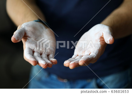 Male hands smeared with magnesium powder ready to workout Male hands smeared with magnesium powder ready to workout 63681653