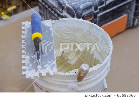 Trowel mortar tIling a closeup with trowel ceramic 63682566