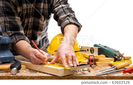 Carpenter at work on wooden boards. Carpentry. Carpenter at work on wooden boards. Carpentry. 63683526