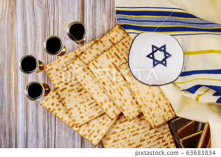 Red kosher wine four glasses of matzah or matza 63683834