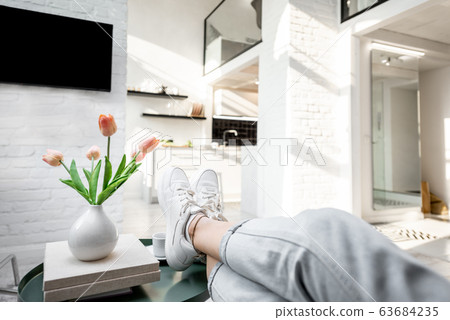 Relaxing in the living room at home 63684235