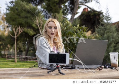 Female blond you tuber with her equipment in action 63684377