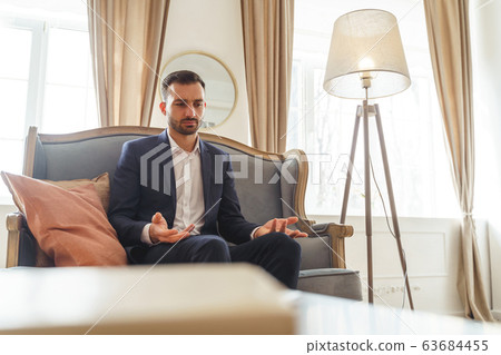Serious young man complaining about his problems Serious young man complaining about his problems 63684455