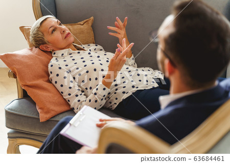 Woman discussing her psychological problems with her doctor 63684461