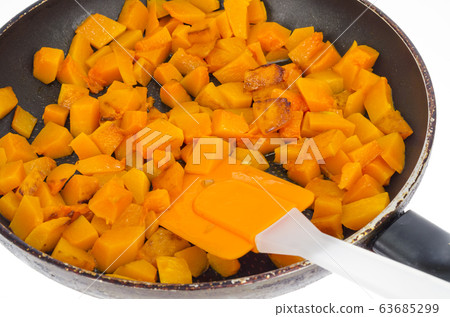 Fried slices of orange nutmeg pumpkin in pan. Fried slices of orange nutmeg pumpkin in pan. 63685299