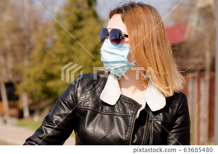 portrait of a woman in a protective mask and 63685480
