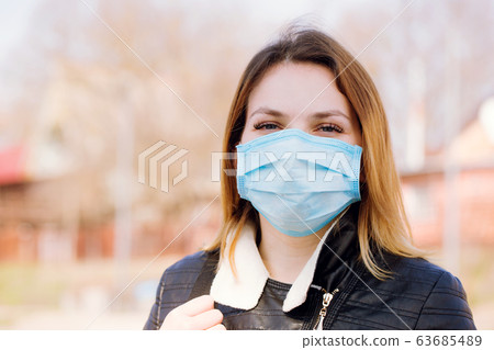 Girl in a protective mask on her face 63685489