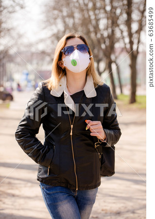 woman in a mask is walking 63685499
