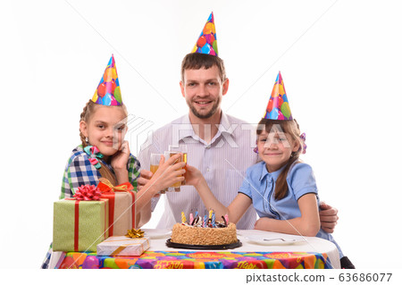 Kids and dad drink juice at a birthday party Kids and dad drink juice at a birthday party 63686077
