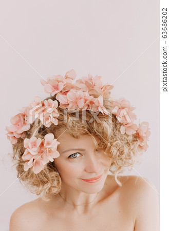 woman holiday flowers wreath pink laugh happiness woman holiday flowers wreath pink laugh happiness 63686202