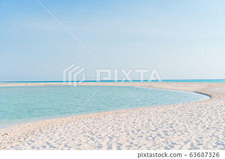 Idyllic tropical beach with white sand, turquoise ocean water and blue sky on Caribbean island 63687326
