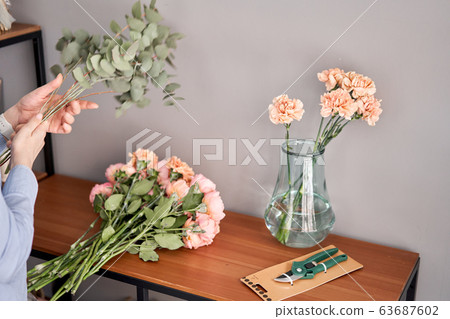 Flower set on wooden table. Fresh cut flowers for decoration home. Delivery flower. 63687602