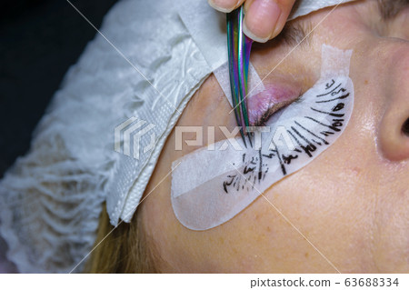 A Woman eye with long black eyelashes. Eyelash 63688334