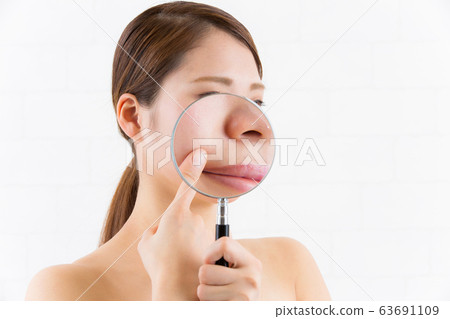 Close up of magnifying glass and laugh line. Close up of magnifying glass and laugh line. 63691109