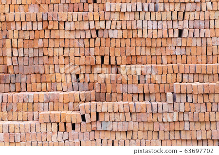 Stack of red clay bricks background 63697702