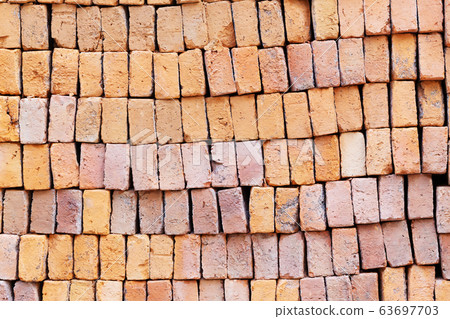 Stack of red clay bricks background Stack of red clay bricks background 63697703
