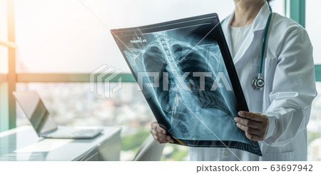 Doctor diagnosing patient health on asthma, lung disease, COVID-19 radiological chest x-ray film  63697942