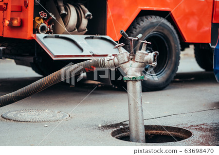 Fire Hydrant In Use During a Structure Fire 63698470