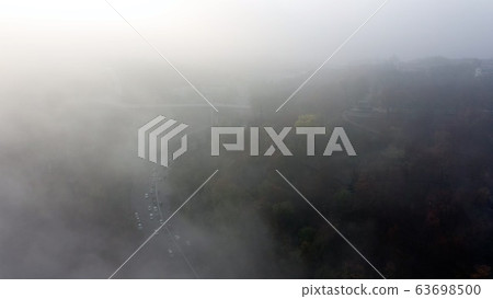 A city covered in fog. City traffic, aerial view A city covered in fog. City traffic, aerial view 63698500