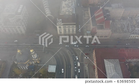 A city covered in fog. City traffic, aerial view 63698505