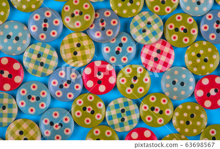 bright background made of multi- colored buttons. 63698567